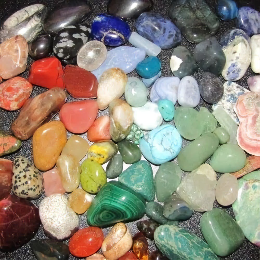 A colorful assortment of polished cabochons and tumbled stones